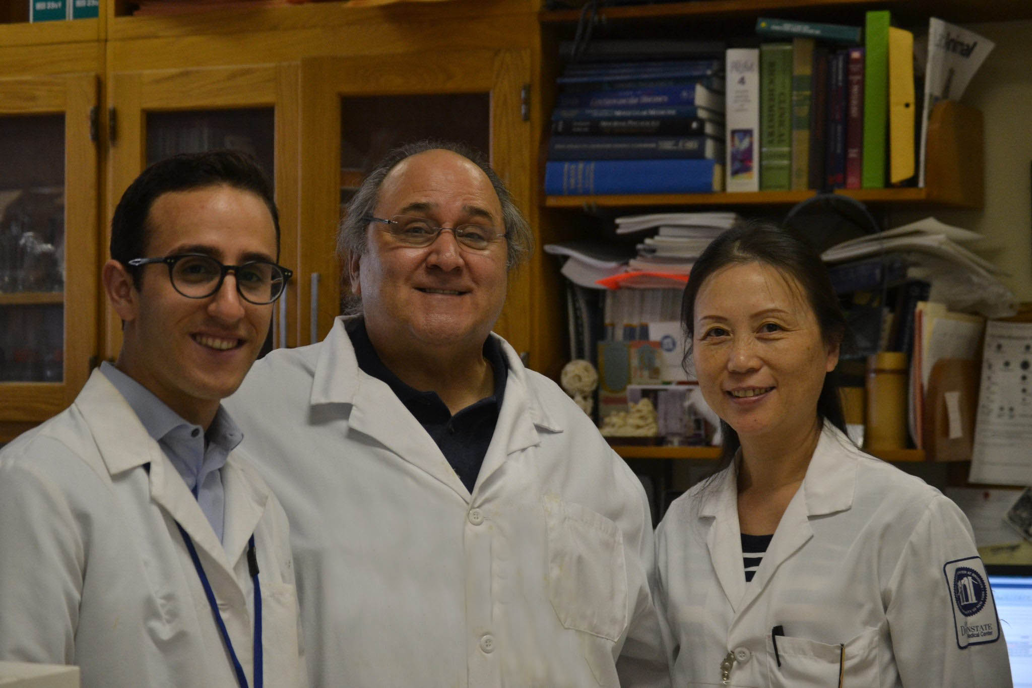 Moshe Bedziner (left) with Dr. Frank Barone (center) and Dr. Jie Li (right) at the SUNY Downstate Medical Center Cerebrovascular Research Laboratory