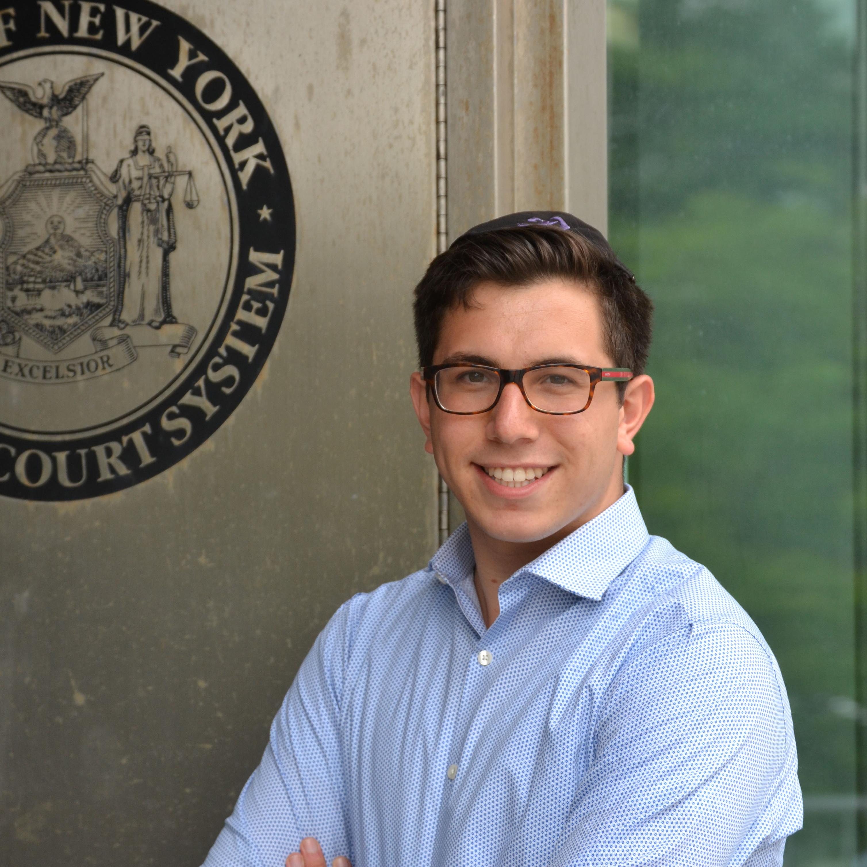LCM alumni Daniel Gabay (\'16) stands outside a New York City court where he had an internship in forensic psychology. 