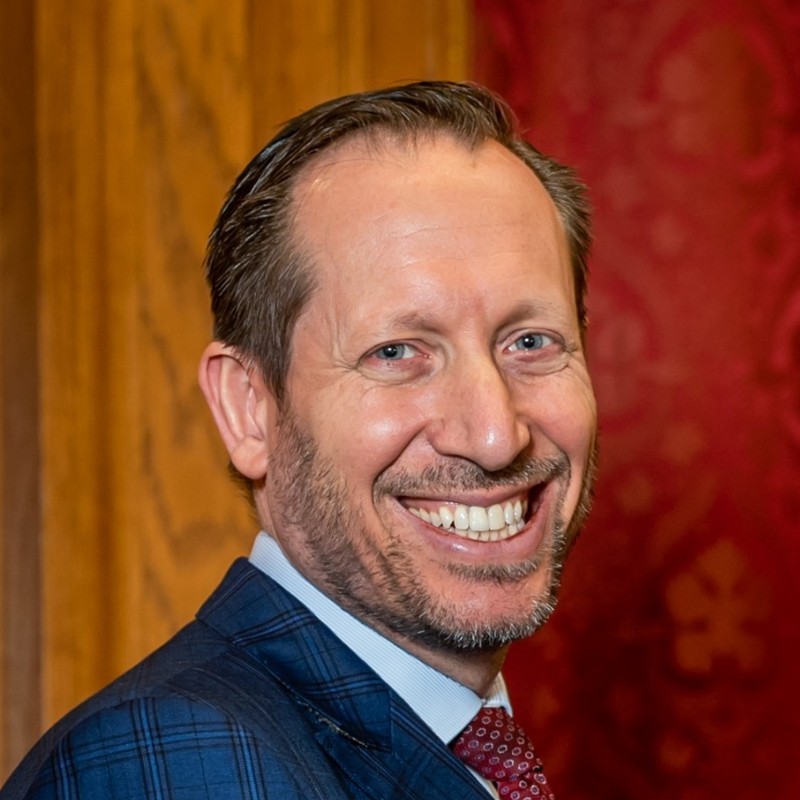 Headshot of Daniel Friedman smiling.