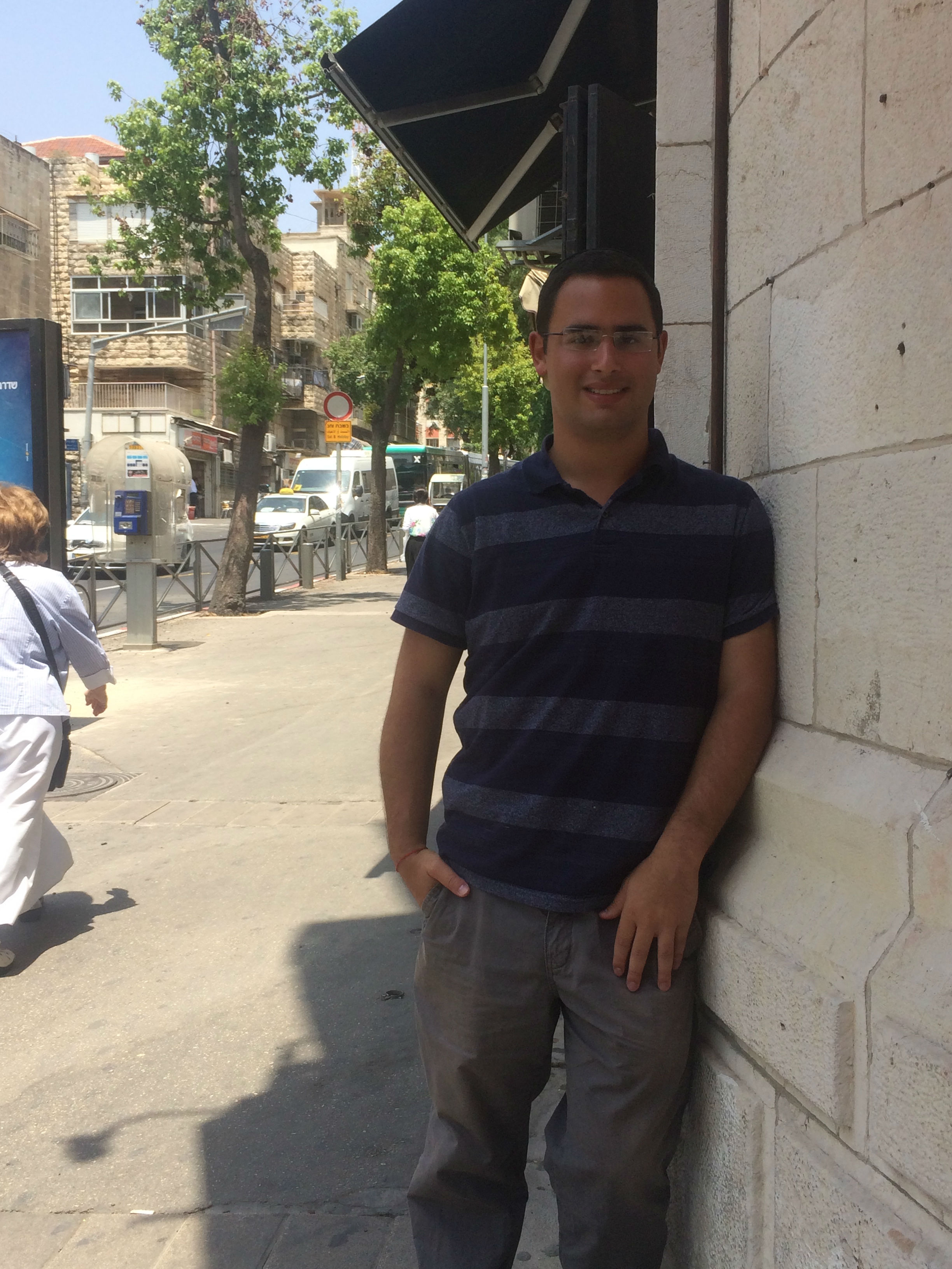 Raphael Gal standing at the entrance of software development company Tobeweb, in Jerusalem, where he interned this summer