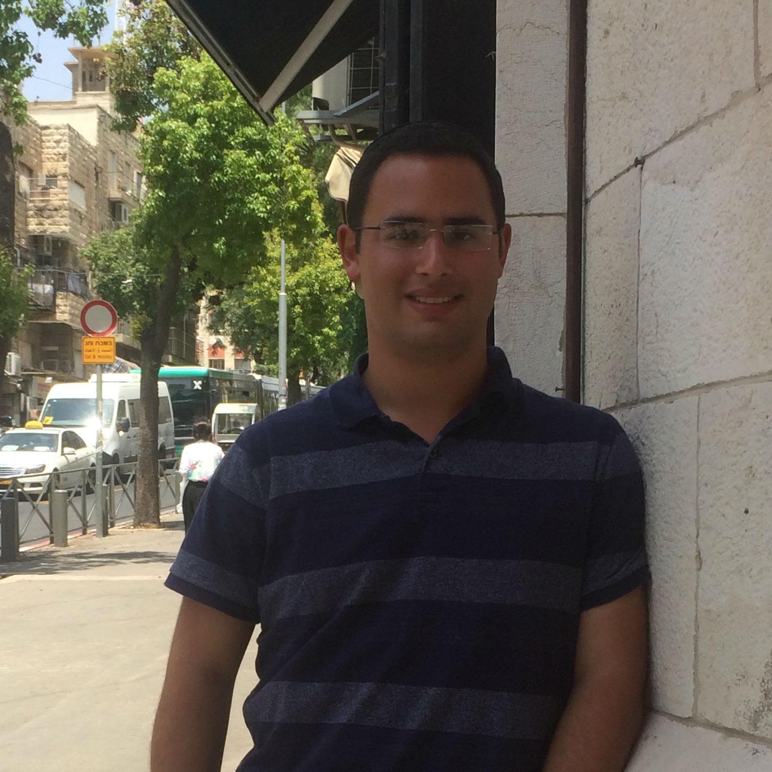 Raphael Gal standing at the entrance of software development company Tobeweb, in Jerusalem, where he interned this summer