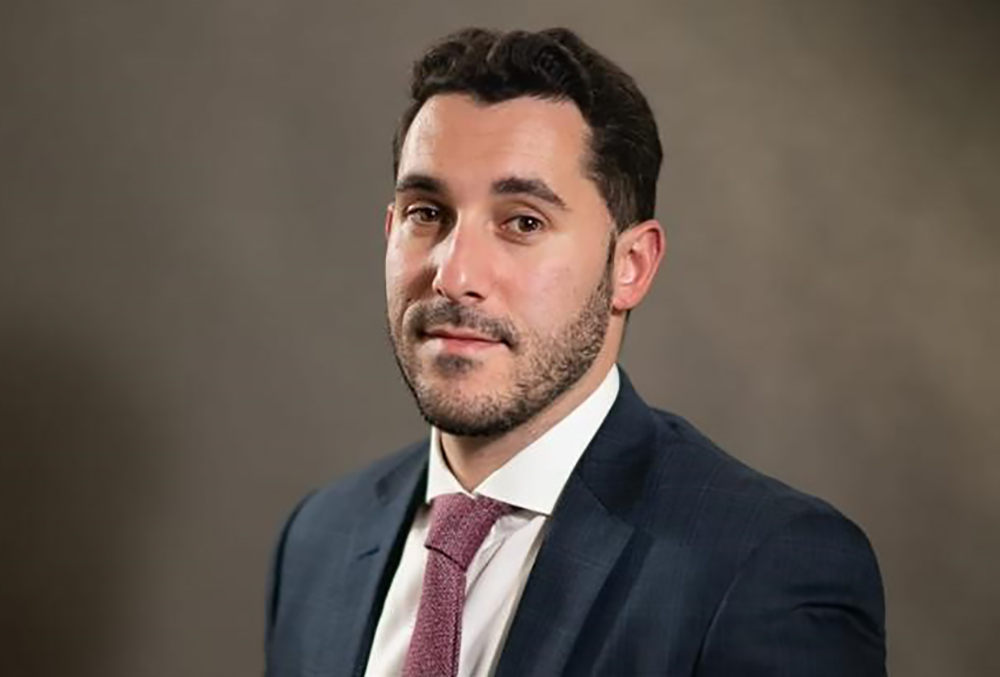 headshot of Aharon Wolf in a suite and tie