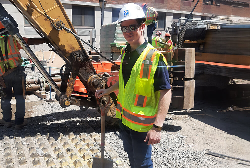 Moses Jeremiah Rybstein standing at a construction site