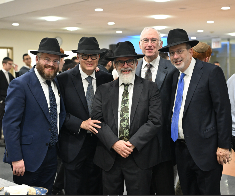 Five men pose for the camera