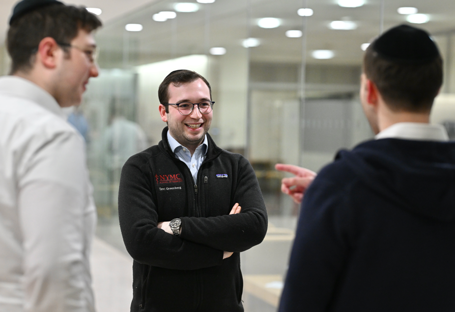 Students engage in conversation in a circle at Lander College for Men.
