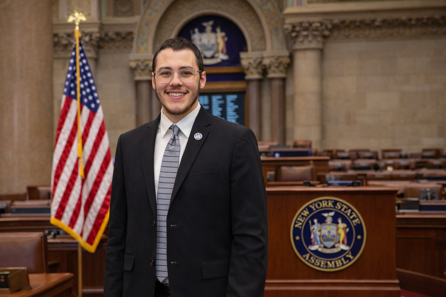 Yehoshuah Rybstein, Lander College for Men part-time student and legislative director for New York State Assemblyman Lester Chang, poses for a picture on the floor of the New York State Assembly.